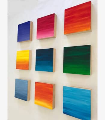 Colorful wood wall sculpture by Paula Gibbs.